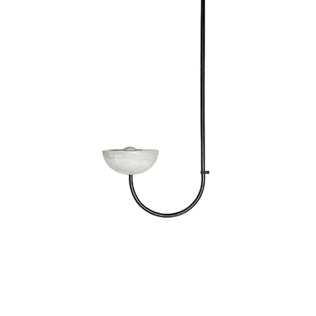 Clérachic single-arm Lunaris pendant in black, the bulb just visible where it sits in the pale alabaster bowl.