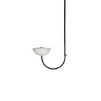 Clérachic single-arm Lunaris pendant in black, the bulb just visible where it sits in the pale alabaster bowl.