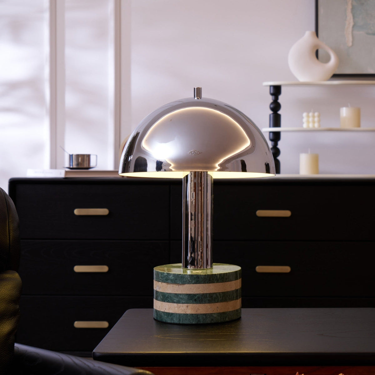 Clérachic lamp lit on the dresser with the candle shelf behind, a wider view taking in more of the dark room.