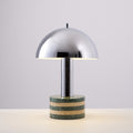 Clérachic table lamp photographed unlit against a plain off-white backdrop, its full chrome dome and marble base visible.