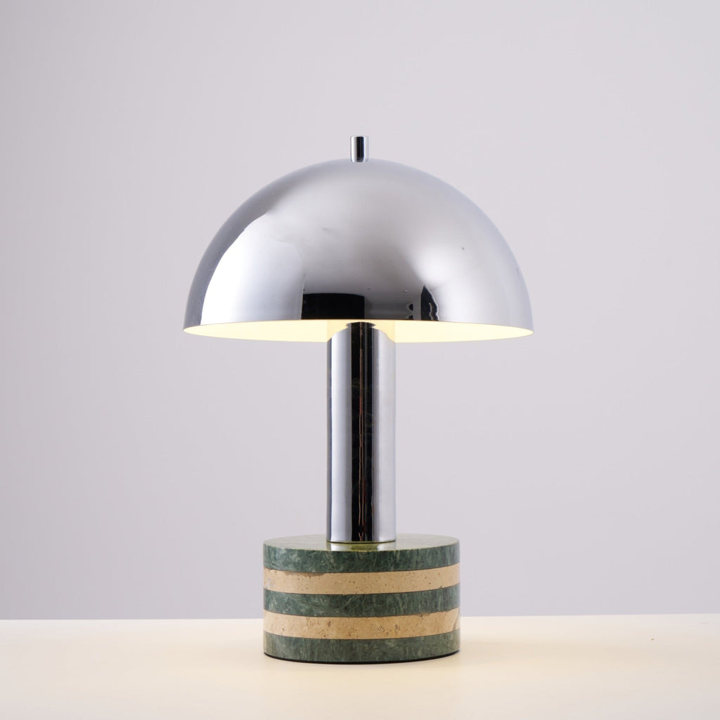 Studio shot of the Clérachic lamp against a plain grey backdrop, dome and striped marble base shown straight-on.