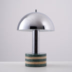 Plain studio shot of the Clérachic lamp straight-on and unlit, showing the full curve of its chrome dome.