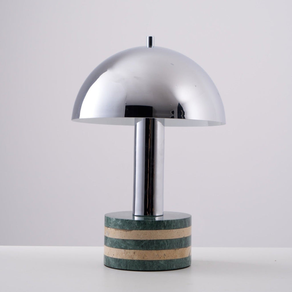 Clérachic lamp at a slight angle against the grey backdrop, its dome catching a soft highlight along one edge.