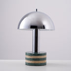 Clérachic lamp at a slight angle against the grey backdrop, its dome catching a soft highlight along one edge.