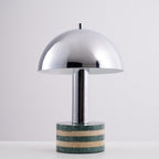 Clérachic lamp angled slightly on the grey backdrop, the striped marble base catching the studio light.