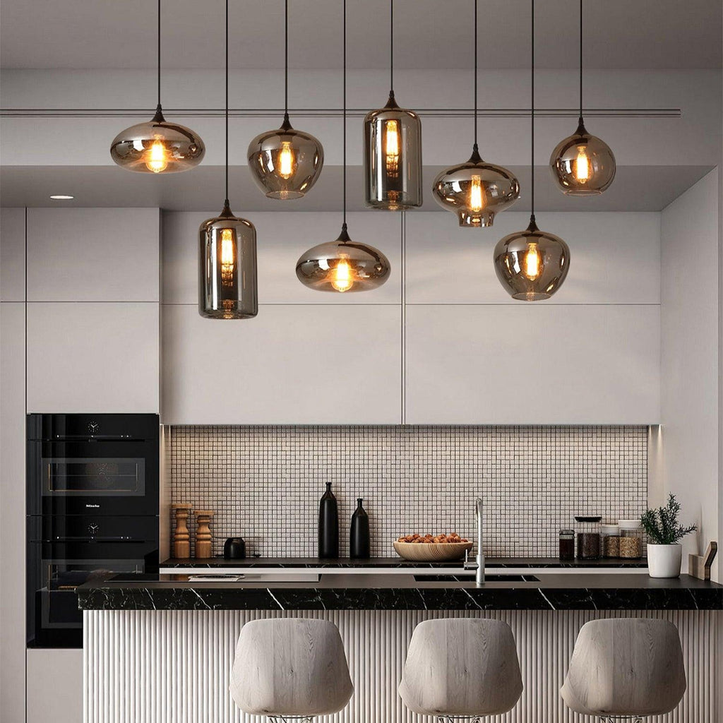Hand-blown smoke gray glass pendant light with warm glow