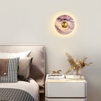 Clérachic's purple marble wall light glows above a taupe headboard and nightstand set with dried flowers and a horse figurine.
