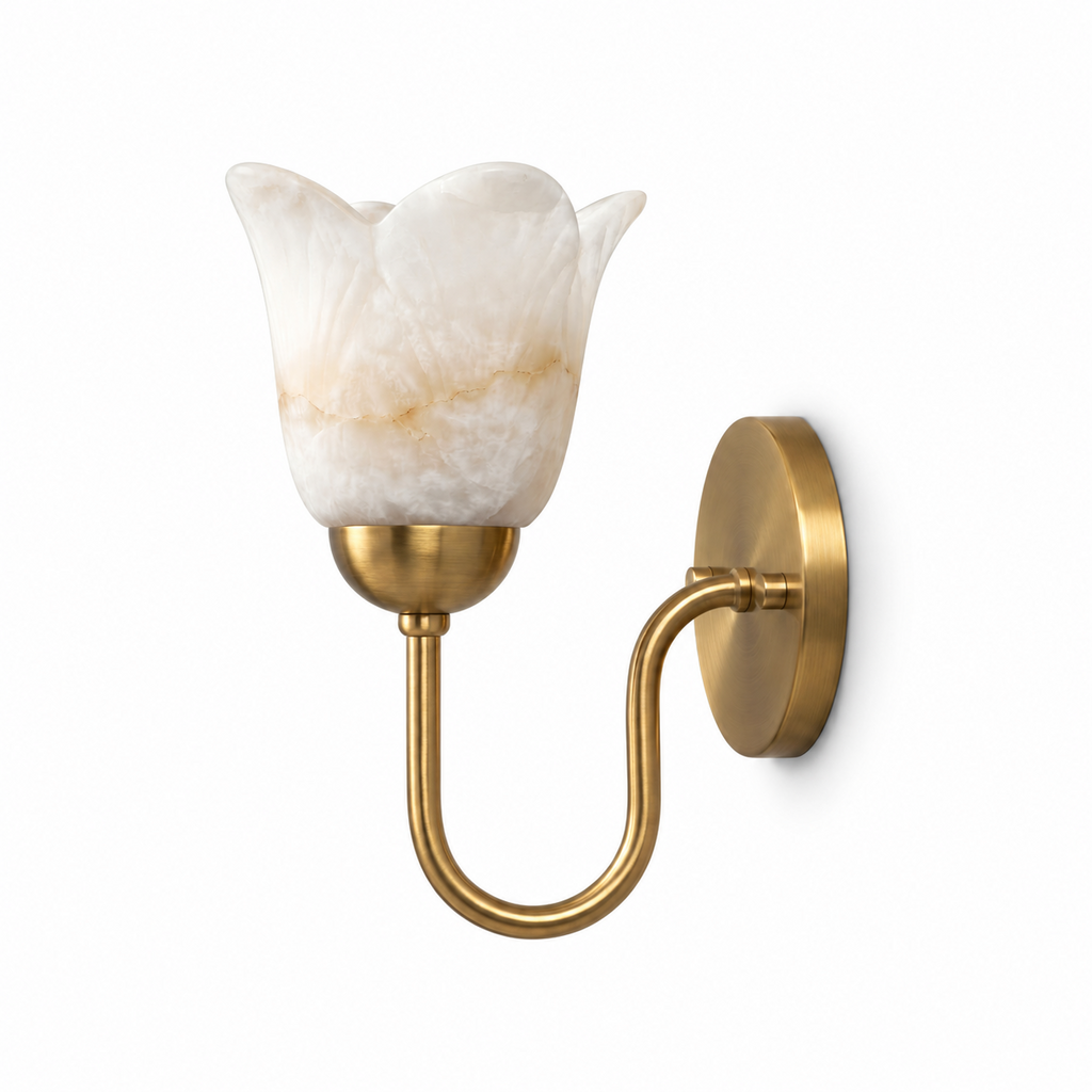 A brushed brass Clérachic wall sconce with a petal-edged alabaster shade, photographed on a plain white background.