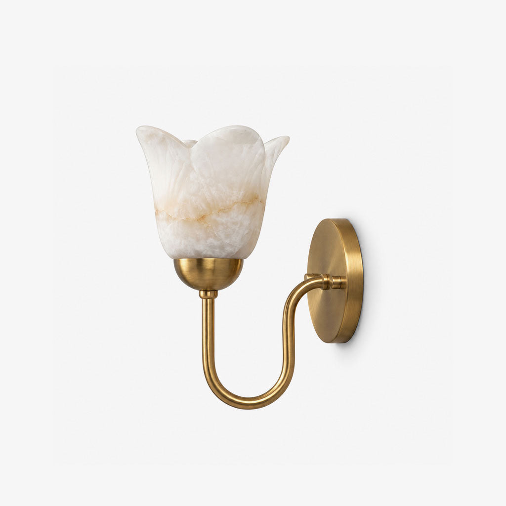 Unlit and shown close, this brushed brass Clérachic wall sconce reveals the soft veining of its alabaster shade.
