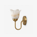Unlit and shown close, this brushed brass Clérachic wall sconce reveals the soft veining of its alabaster shade.