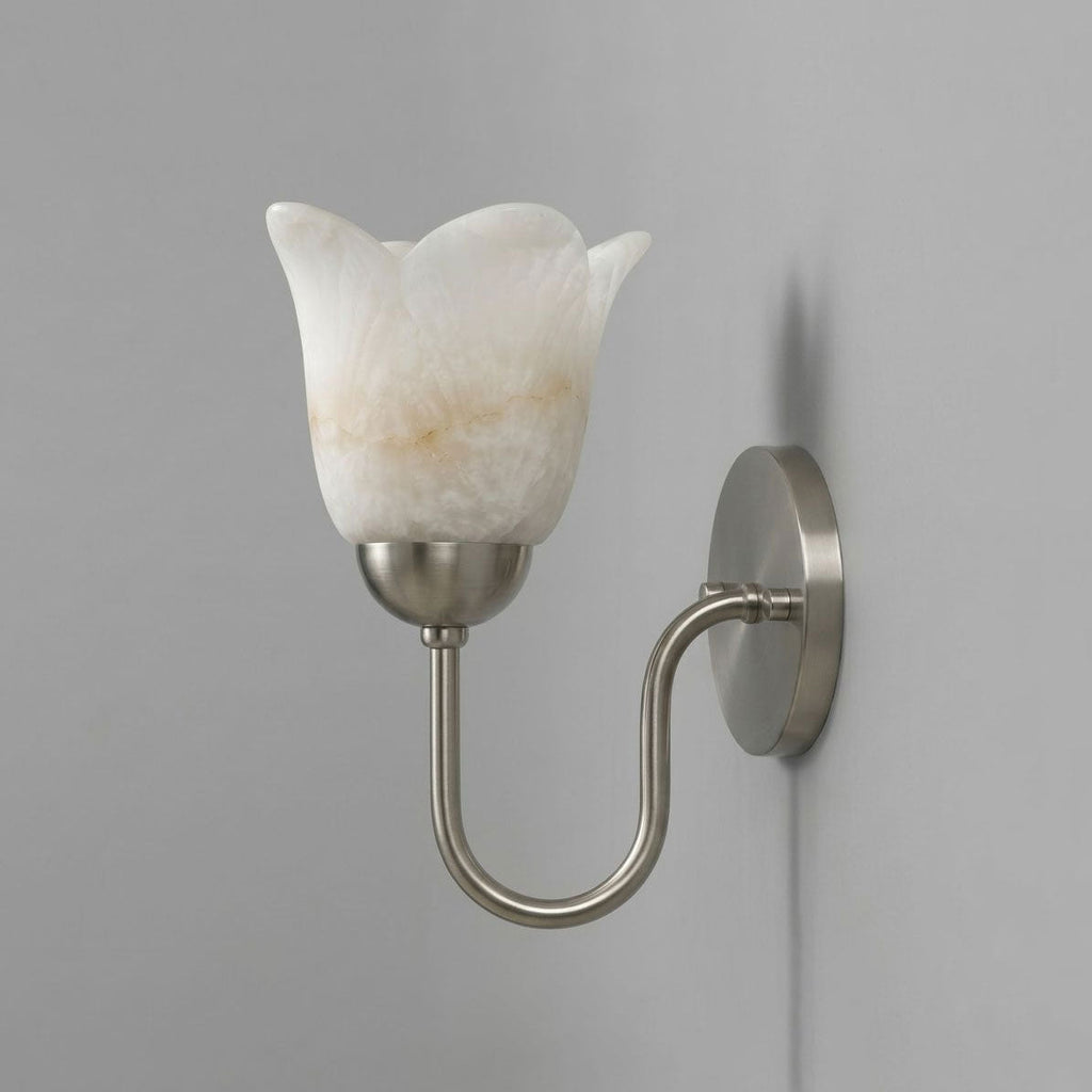 Unlit against a grey wall, this brushed nickel Clérachic wall sconce shows its alabaster shade and visible plug cord.
