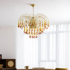 Caramel crystal drops on this Clérachic pendant catch the light beside a mustard-yellow chair and dark wood shelving.