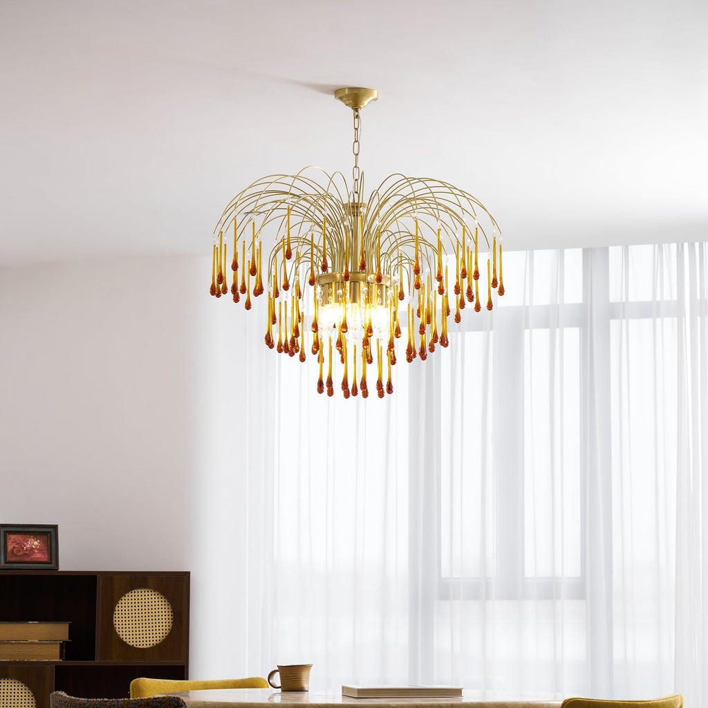 Warm light glows through this Clérachic pendant's caramel crystal drops, hung near a framed photo on dark wood shelving.