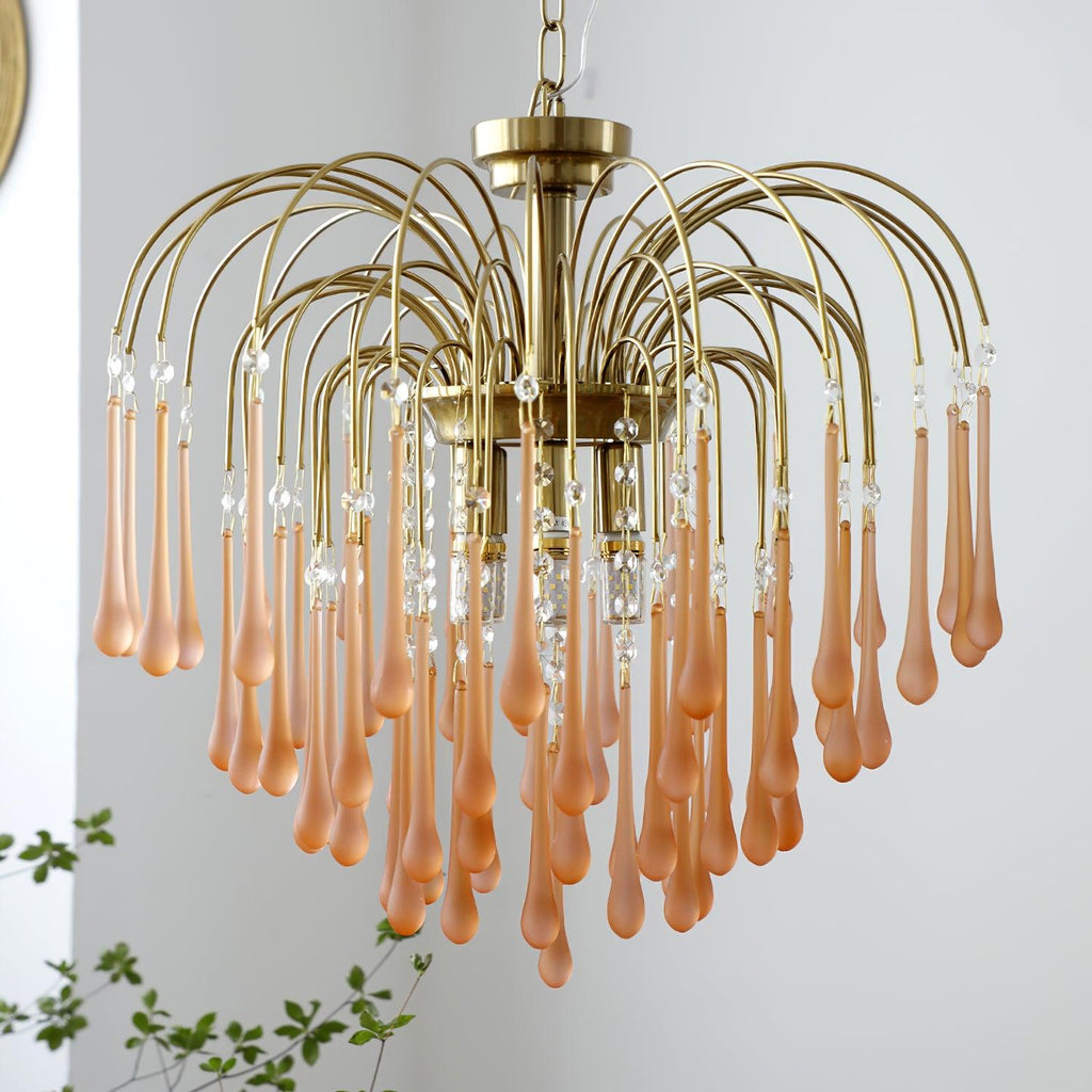 A softer blush-caramel tone shows on this Clérachic chandelier's crystal drops, spread wide in a fountain shape on a plain background.