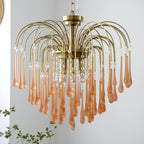 A softer blush-caramel tone shows on this Clérachic chandelier's crystal drops, spread wide in a fountain shape on a plain background.