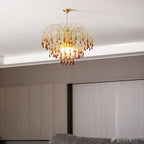 A closer view of this Clérachic pendant shows its lit caramel crystal drops against ceiling trim and pale panelling.