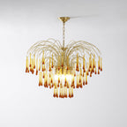 A wide fountain shape of caramel crystal drops spreads from this Clérachic pendant, lit on a plain background.