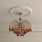 This Clérachic pendant hangs from an ornate ceiling medallion, its caramel crystal drops close beneath the moulded rose.