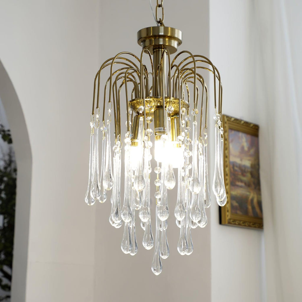 This Clérachic pendant hangs near an arched doorway and framed picture, its clear crystal drops lit warm.