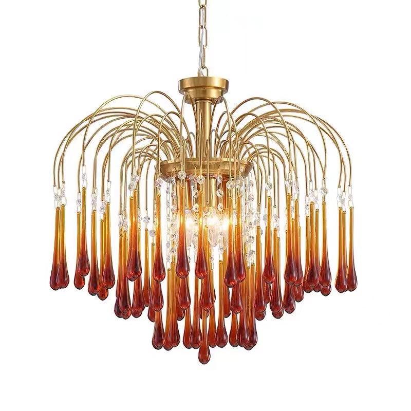 Product shot of this Clérachic chandelier lit on white, caramel crystal drops tiered beneath clear crystal accents at the centre.