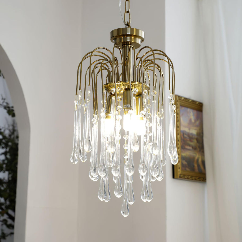 This Clérachic pendant's clear crystal drops hang beside a gilt-framed picture near an arched doorway.