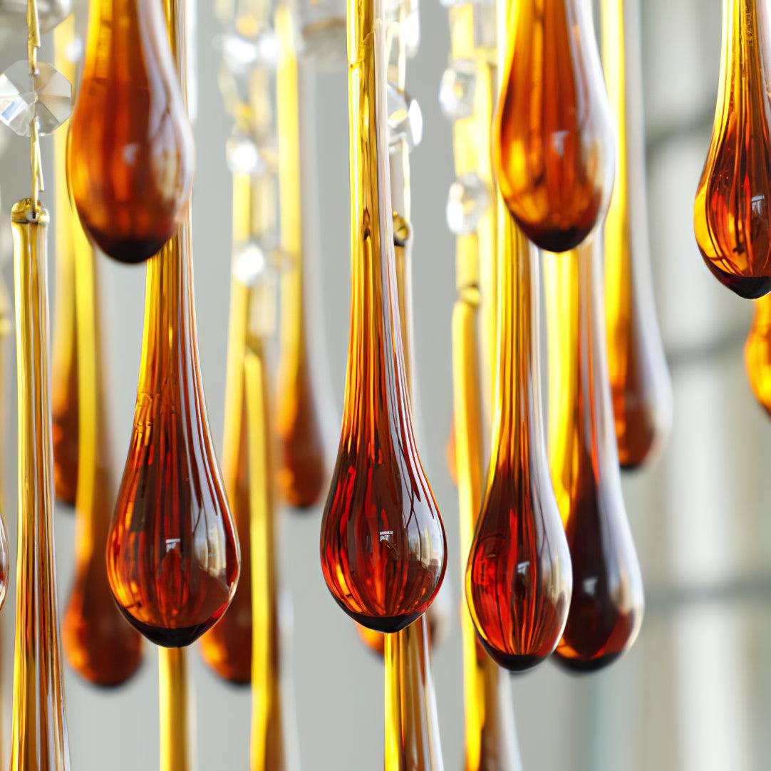 Close view of the caramel glass teardrops on this Clérachic chandelier, their colour deepening from amber to red-brown.