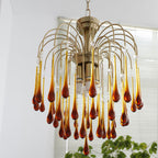 This Clérachic chandelier's caramel and clear crystal drops cascade past white venetian blinds in the background.