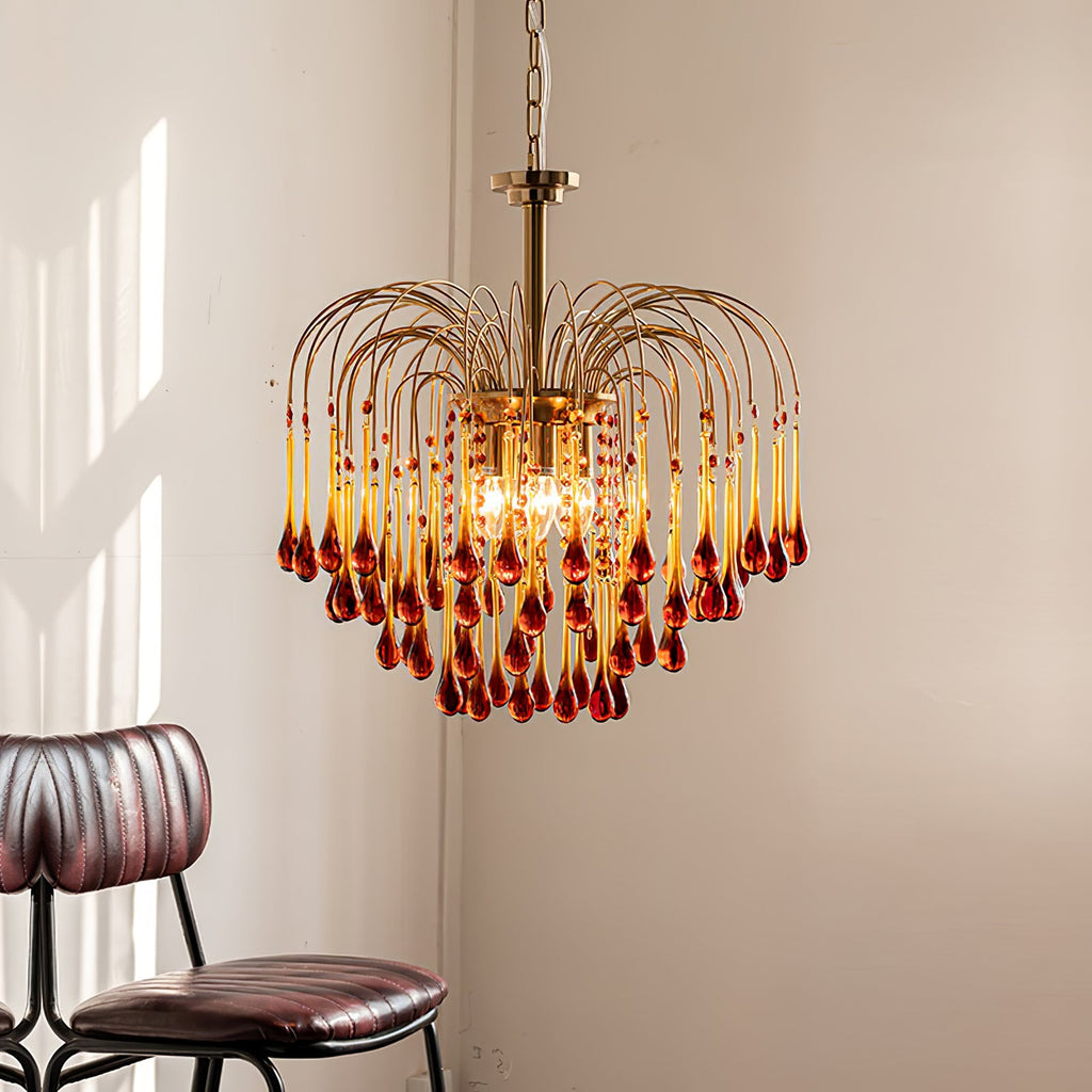 Sunlight catches the caramel crystal drops of this Clérachic chandelier, hung in a corner beside a dark leather chair.