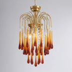 A fuller version of this Clérachic chandelier mixes caramel and clear crystal drops, lit brightly against dark grey.