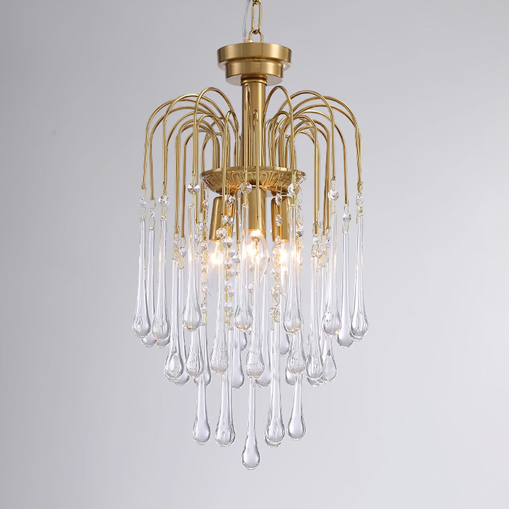 This Clérachic pendant's clear crystal drops are lit against a dark grey background, tiers layered beneath the brass arms.