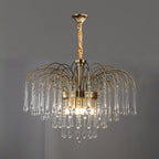 A twisted cord replaces the chain on this Clérachic chandelier, its clear crystal drops lit against a dark grey backdrop.