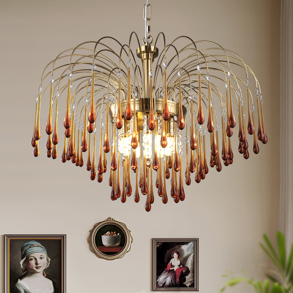 This Clérachic chandelier's mix of caramel and clear crystal drops hangs before a wall of framed vintage portraits.