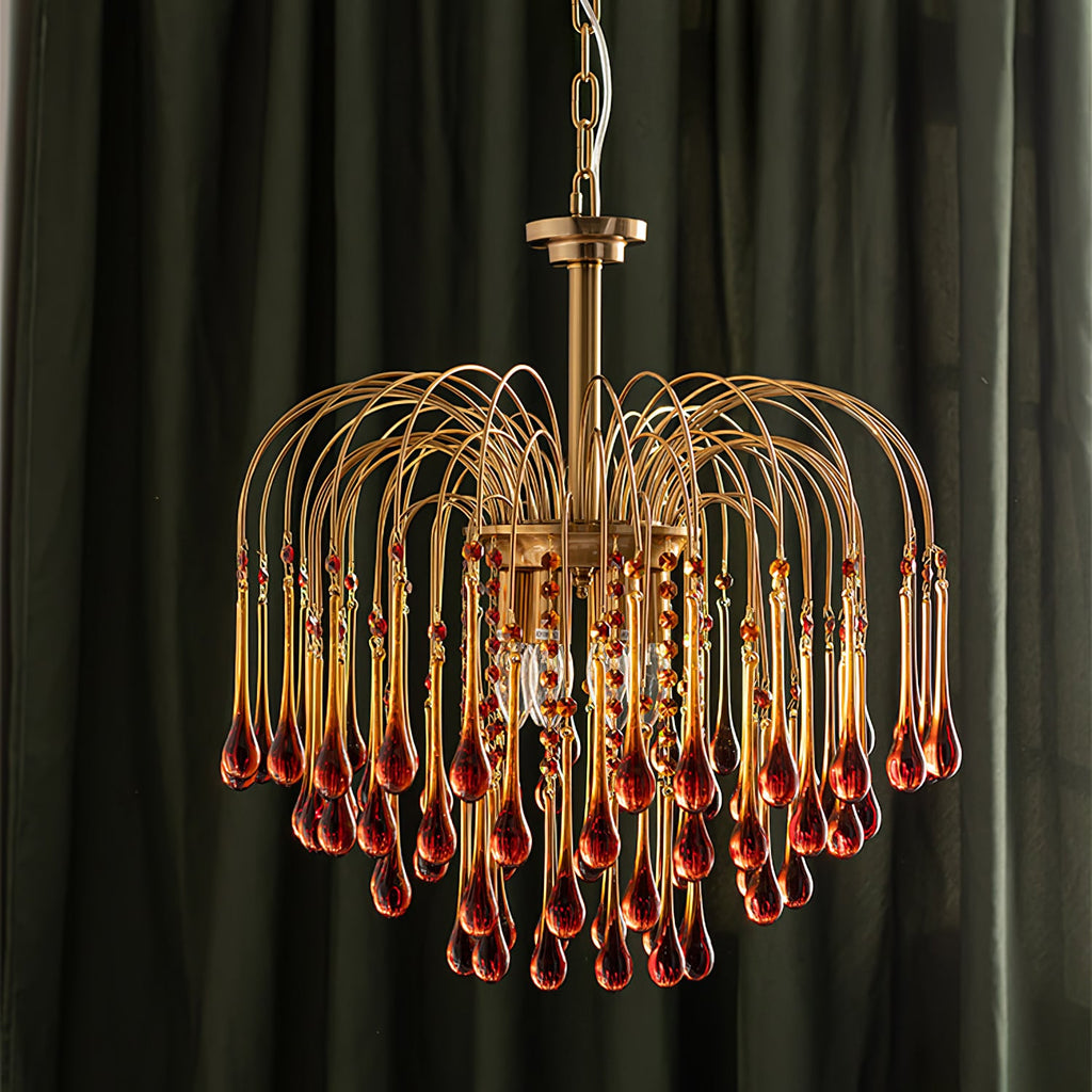 Deep caramel crystal drops on this Clérachic pendant stand out against a dark green curtain, lit warm.