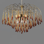 This large Clérachic chandelier's caramel crystal drops mix with clear accents, lit against a dark grey backdrop.
