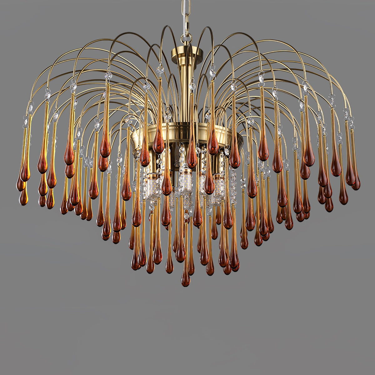 This large Clérachic chandelier's caramel crystal drops mix with clear accents, lit against a dark grey backdrop.