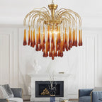 Caramel and clear crystal drops on this Clérachic chandelier hang above a white mantelpiece with a vase of branches nearby.