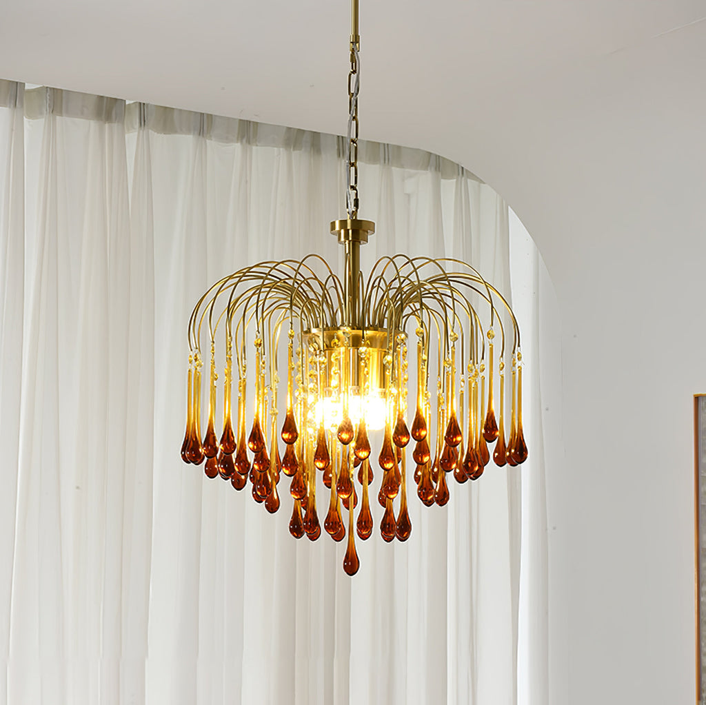 Sheer white curtains frame this Clérachic chandelier, its caramel crystal drops lit against the soft daylight.