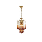 A slender version of this Clérachic pendant shows its caramel crystal drops isolated and lit on white.