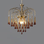 This Clérachic pendant's caramel crystal drops hang with clear accents near the centre, lit against dark grey.