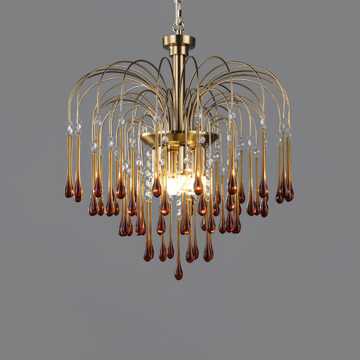 This Clérachic pendant's caramel crystal drops hang with clear accents near the centre, lit against dark grey.