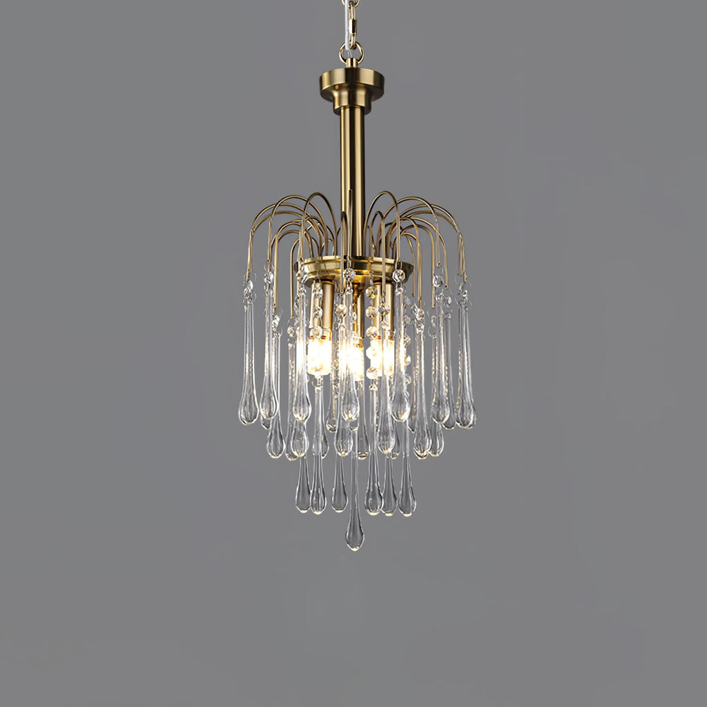 The brass arms of this Clérachic pendant arc above clear crystal drops, lit against dark grey.