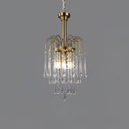 The brass arms of this Clérachic pendant arc above clear crystal drops, lit against dark grey.
