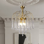 This Clérachic pendant's clear crystal drops hang beside ornate white cornicing and a framed piece of art.