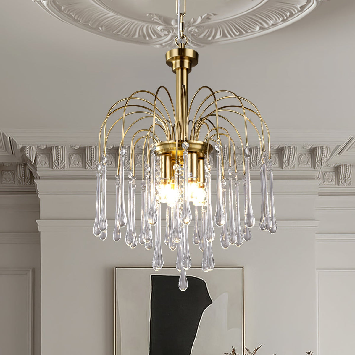 This Clérachic pendant's clear crystal drops hang beside ornate white cornicing and a framed piece of art.