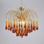 This large Clérachic chandelier's caramel crystal drops hang with clear accents, lit brightly on a plain background.
