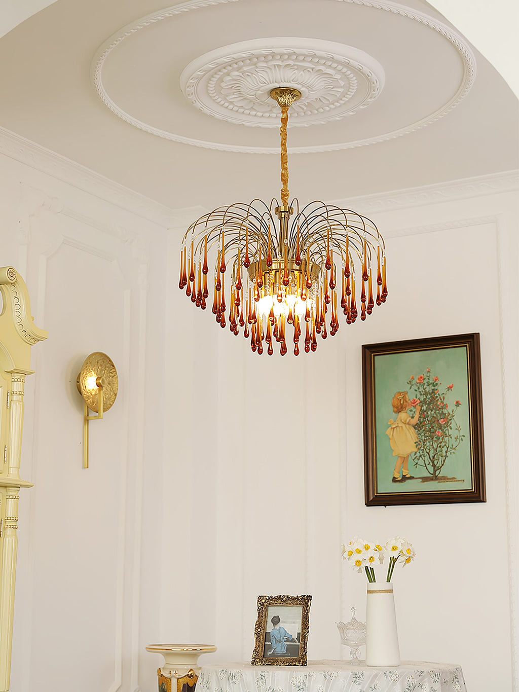 This Clérachic pendant hangs in an elegant room with an ornate ceiling medallion, wall sconce and framed picture nearby.
