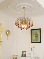 This Clérachic pendant hangs in an elegant room with an ornate ceiling medallion, wall sconce and framed picture nearby.