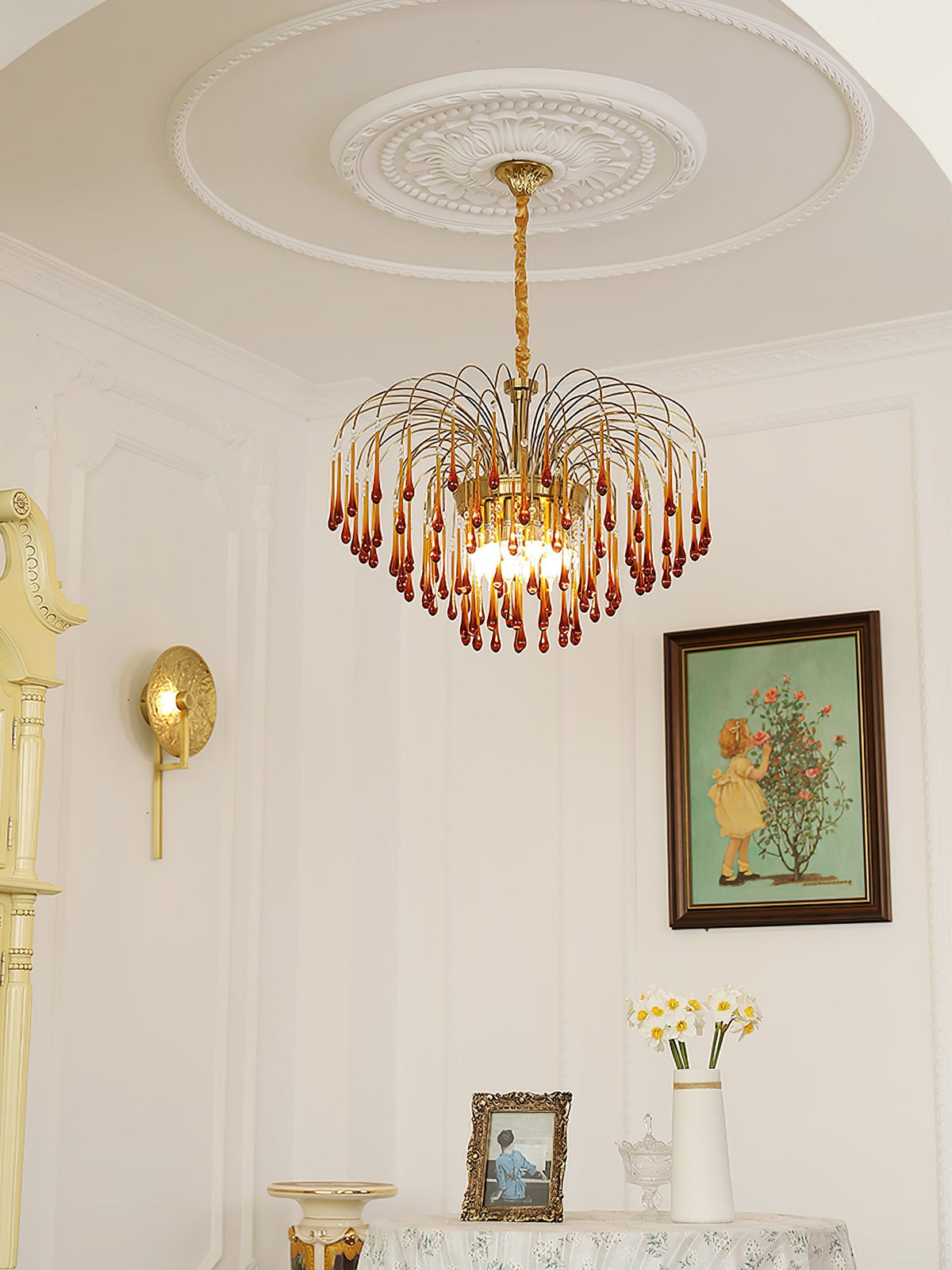 This Clérachic pendant hangs in an elegant room with an ornate ceiling medallion, wall sconce and framed picture nearby.