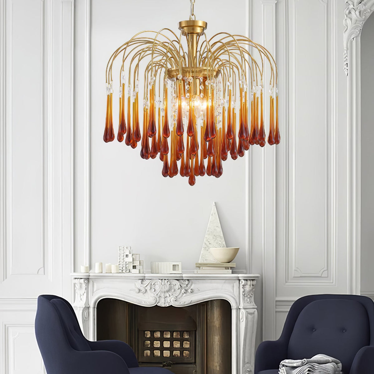 This Clérachic chandelier hangs above a white mantelpiece flanked by navy armchairs, its caramel crystals glowing warm.