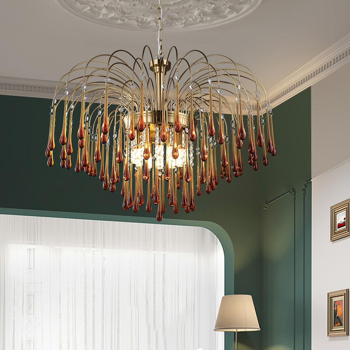 This Clérachic chandelier hangs in a room with a dark green wall, sheer curtain and small table lamp nearby.
